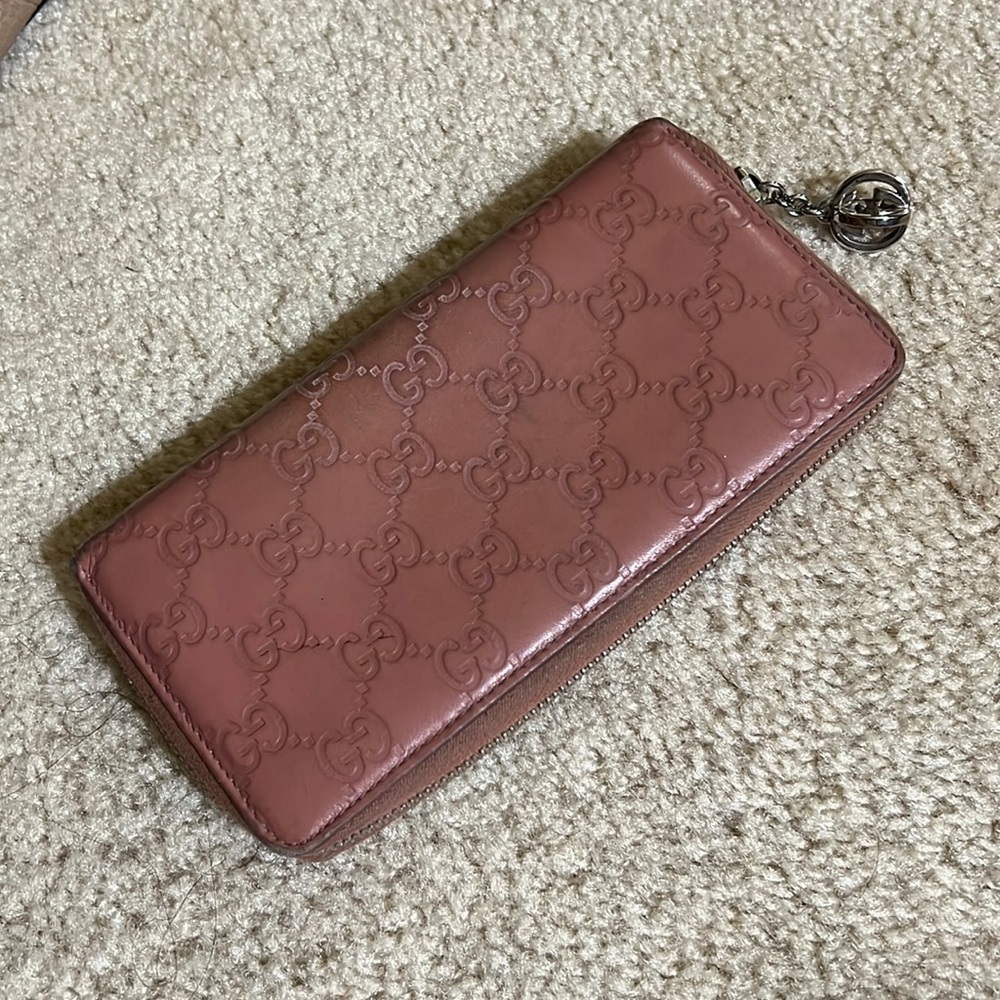 Gucci women’s leather wallet, embossed with Gucci logo